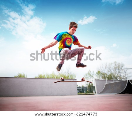 Skater doing kickflip in skatepark
