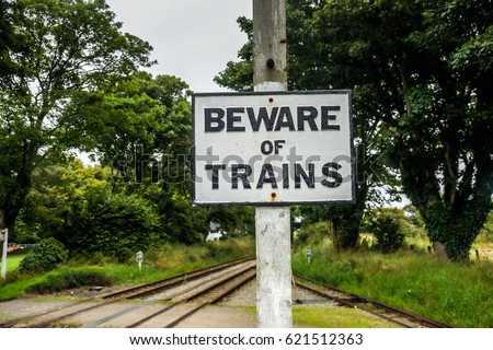 Railroad sign. Beware sign of Trains.Rail traffic signs. Rail crossing signs. Railroad safety notification symbol. Isle of Man rail station.Aluminum plate signs. Lifesaver symbol Warning railroad sign