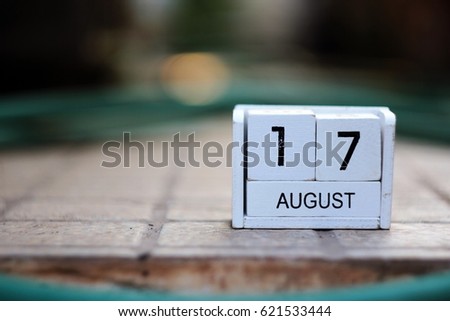White wooden calendar on grunge concrete. items to tell date, symbol of appointment, reminder, planner or meeting. Vintage idea shows 17 August