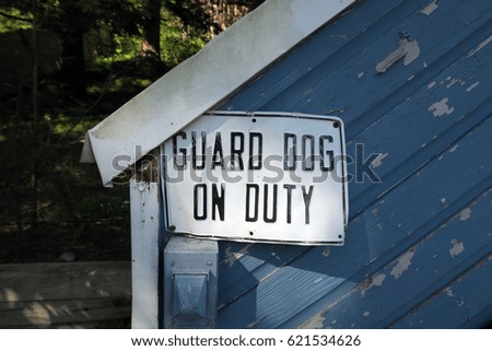 Sign that says, "GUARD DOG ON DUTY". 