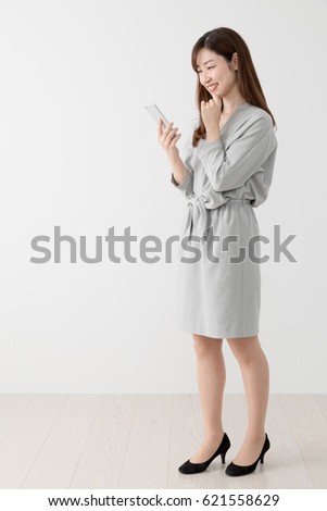 Woman using mobile phone, business