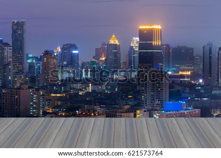 Opening wooden floor, Night office building light aerial view, cityscape downtown background