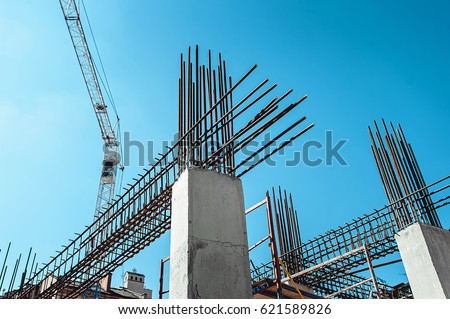 Steel Frames of A Building Under Construction, With Tower Crane On Top Royalty-Free Stock Photo #621589826