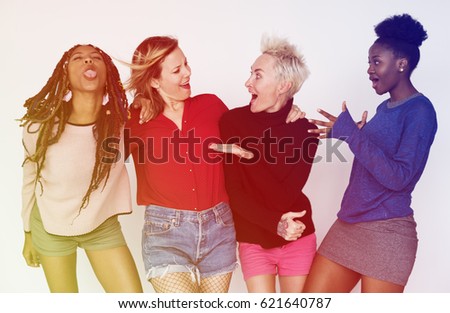 Women standing and posing for picture in funny style
