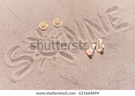 Word sun (Sonne) in german written on the sand of the beach
