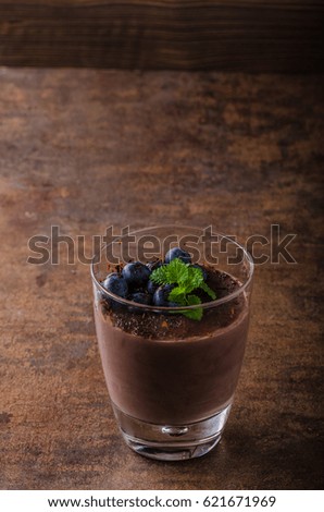 Chocolate pudding with berries and herbs, vintage rustic food styled picture, for your advertisment