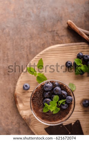 Chocolate pudding with berries and herbs, vintage rustic food styled picture, for your advertisment