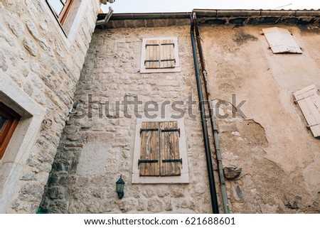 White window shutters. The facade of houses in Montenegro.
