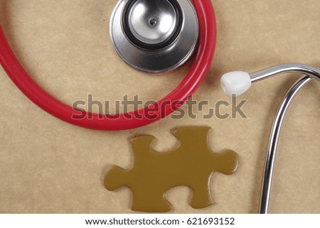 Medical concept with stethoscope,piece of puzzle and coins .