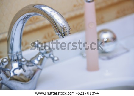 Close-up photo of the chrome water tap and sink