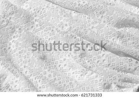 Texture, background, pattern. White girl's skirt, with a broken pattern in the form of circles. White lace cotton
