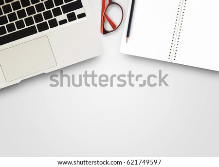 Top view office desk. notebook and laptop computer and red glasses on white background. Top view with copy space for design