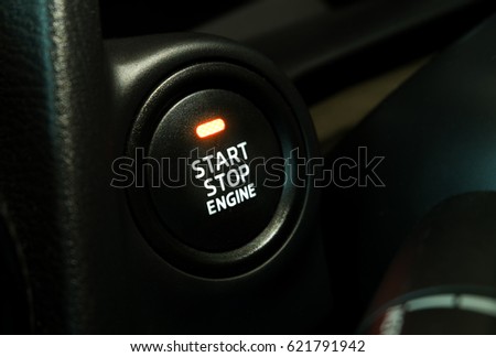 black button with text start stop engine and orange symbol light on my car.