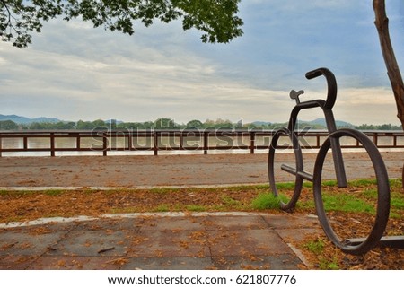 View of bicycle parking symbol near the river.