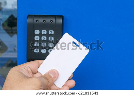 Door access control - woman holding a key card to lock and unlock door., Keycard touch the security system to access the door