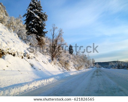 Winter snow road. Siberia. Blue sky