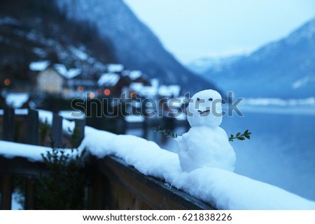Diy Snowman on the balcony with a lake in Hallstatt, Austria view/copy space / Christmas 