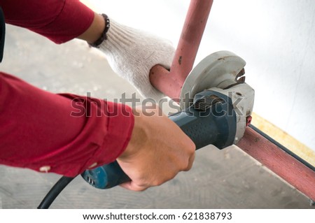Worker cuttiing steel