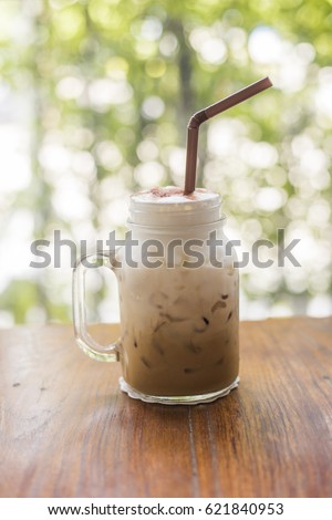 Ice coffee with milk on the wooden table