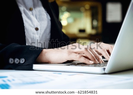 Closeup photo of female hands typing text on keyboard in coffee shop.business woman hands busy using laptop  working at office desk,student typing on computer sitting at wooden table