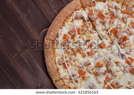 Tasty beautiful pizza on a wooden background