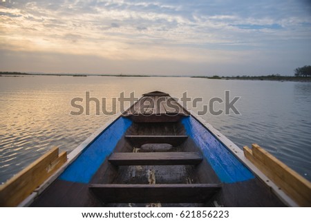 Small wooden boat in the morning at sunrise.