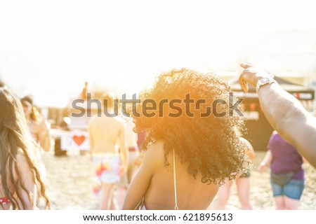 Young people dancing on beach party in summer time - Cheerful multi ethnic having fun outdoor - New music entertainment trends - Focus on black girl afro hair- Unfiltered photo with back flare light