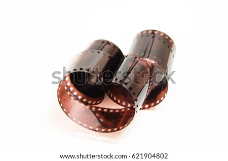 Curled film ribbon isolated on white background