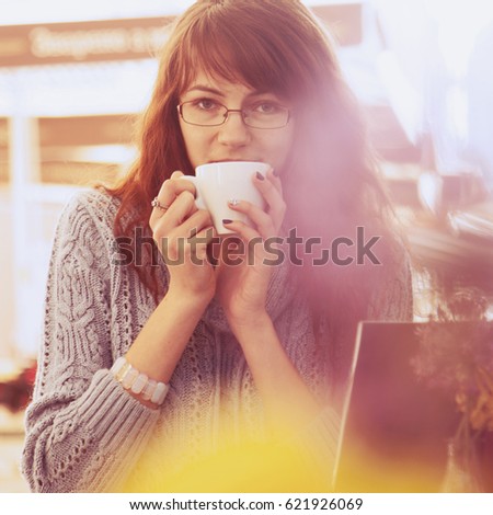 Beautiful business woman enjoying in a cup of coffee