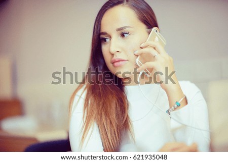 Beautiful brunette speaks by phone portrait female