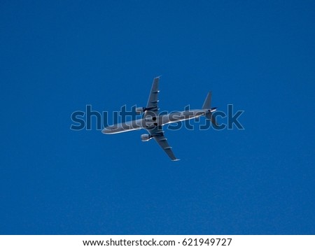 Photo of a passenger airplane flying over.
