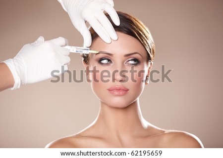 Beautiful woman gets injection in her face Royalty-Free Stock Photo #62195659