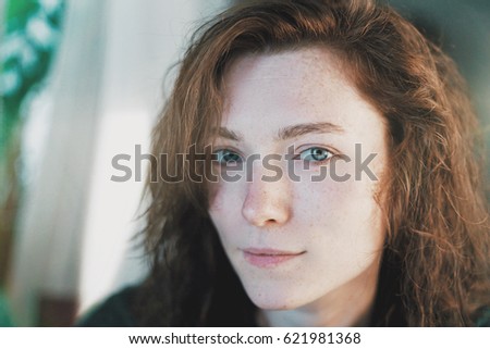 Beautiful portrait of red hair woman. Light leak and film effects. Blurred background