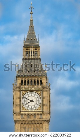 Close up of the clock face of Big Ben in Westminster, London on a cloudy day.
