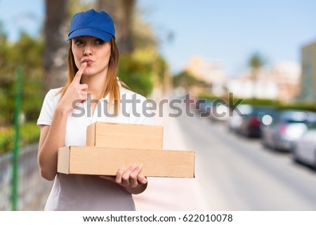 Delivery woman thinking on unfocused background
