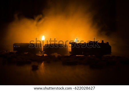 Train moving in fog. Ancient steam locomotive in night. Night train moving on railroad. orange fire background. Horror mystical scene