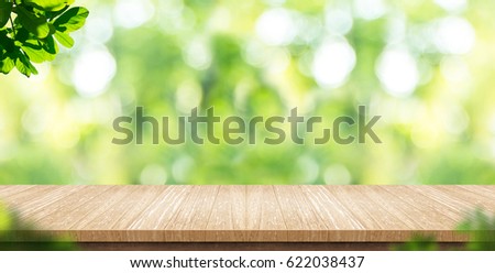 Empty wood plank table top with blur park green nature background bokeh light,Mock up for display or montage of product,Banner or header for advertise on social media,Spring and Summer concept