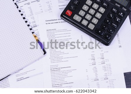 Business accessories - diary, calculator laying on business documents.