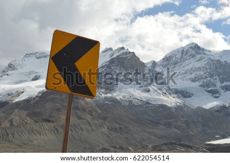 Weathered road sign in mountain range