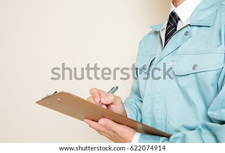 A young man wearing work clothes Royalty-Free Stock Photo #622074914