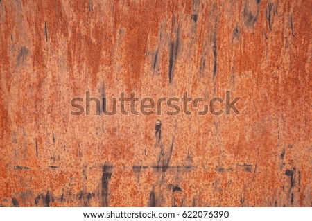 Patterns of rust and colored paint on metal