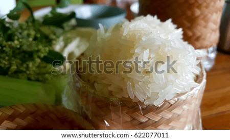 Warm and fresh soft sticky rice in bamboo basket on dinner table 