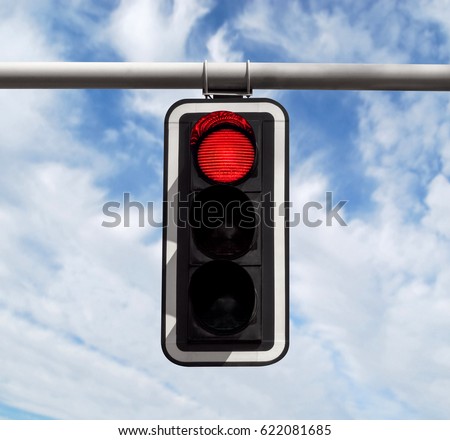 Red traffic light against blue sky background with Clipping Path