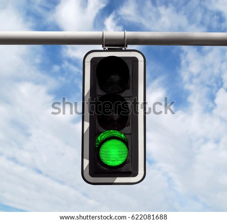 Green traffic light against blue sky background with Clipping Path Royalty-Free Stock Photo #622081688