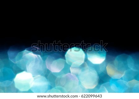 Abstract blue  glitter lights isolated on black background. Round defocused circles bokeh and shine glitters bright light. Template for design