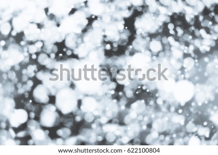 Abstract silver background with white particles. Round bokeh or glitter lights. Design template