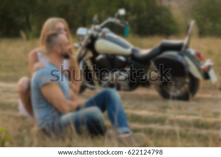 Young couple in a field.Background blur