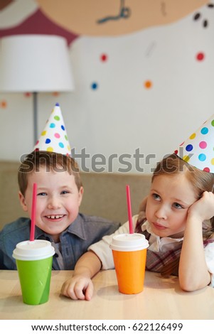 Little boy and girl with different emotions during party
