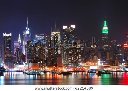 Empire State Building, New York City with Manhattan Skyline at night panorama over Hudson River with reflection.