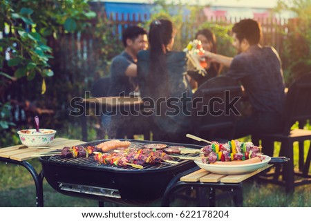 Dinner party, barbecue and roast pork at night Royalty-Free Stock Photo #622178204